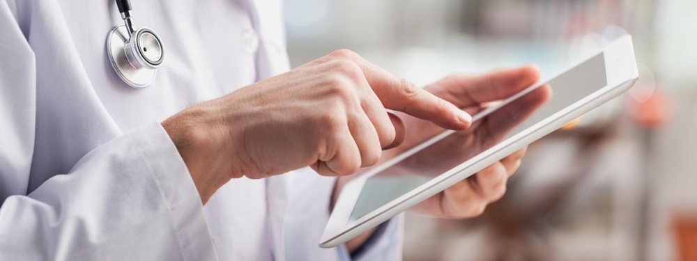 Doctors hands on tablet